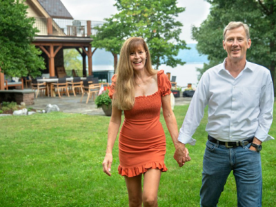 Peter and Stephanie Nolan hold hands and smile as they walk