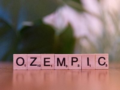 ozempic scrabble tiles on wooden surface