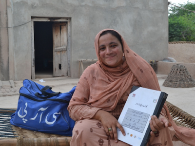 A community resource person in Pakistan, with her bag of products.