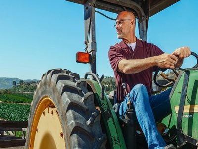 Image of a male farmer on a tractor