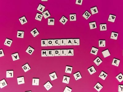Tiles spelling "Social Media" with random letter tiles scattered around