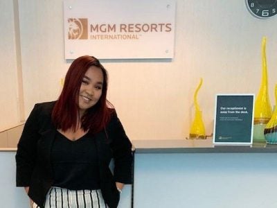 Quyen standing in front of the MGM Resorts logo