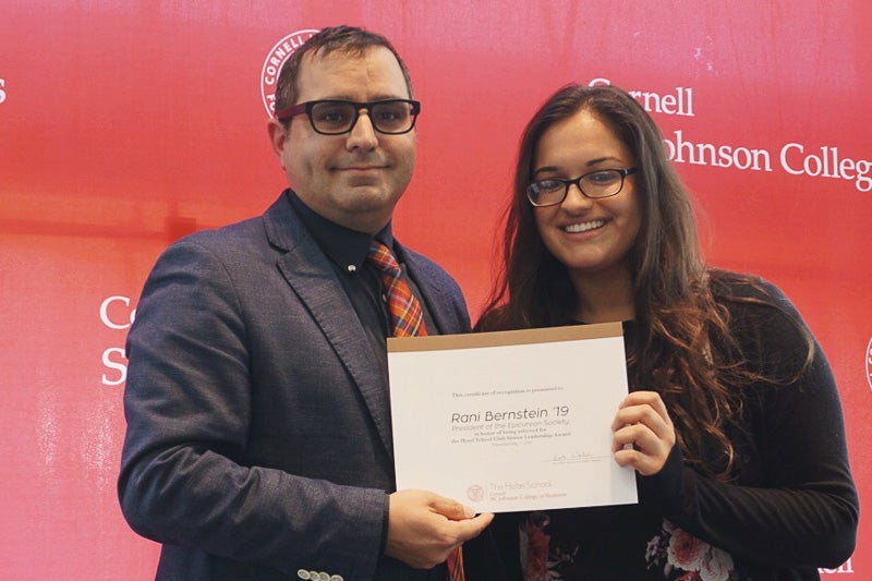 Photo of Rabinder and Rani holding a certificate