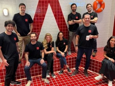 Pedro Tucci with the Antler Brazil team sitting and standing as a group.