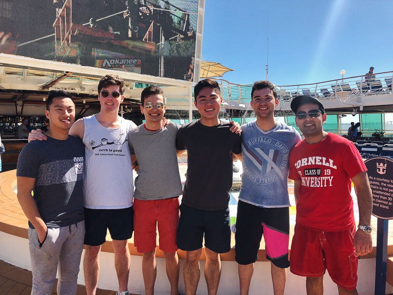 Photo of six students standing on the ship deck