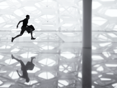 silhouette of man running with a brief case at airport