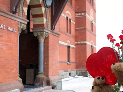 Photo of Sage Hall with a box of Valentine's Day chocolate