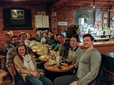 Photo of students sitting at a long table in a restaurant