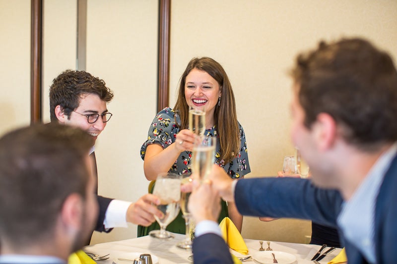 Photo of Kayti Stanley holding a glass for a toast
