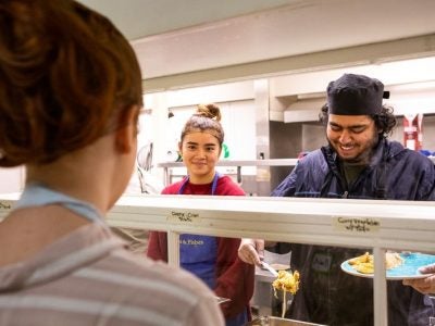 A student serving a meal