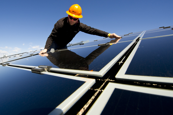 man fixing solar panel