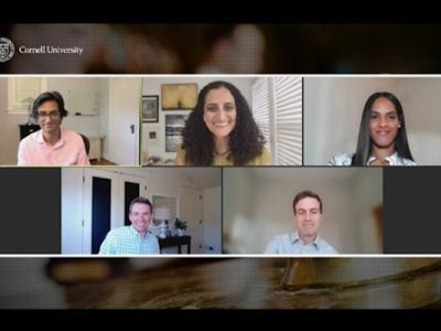 A screenshot, showing the five webinar panelists smiling during the online event.