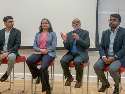 Authors speaking on a panel at the launch event