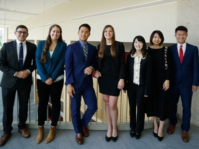 Photo of seven Hotelies on The 180 executive board standing in Statler Hall