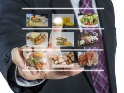 Stock image of a person pointing to a screen of photos