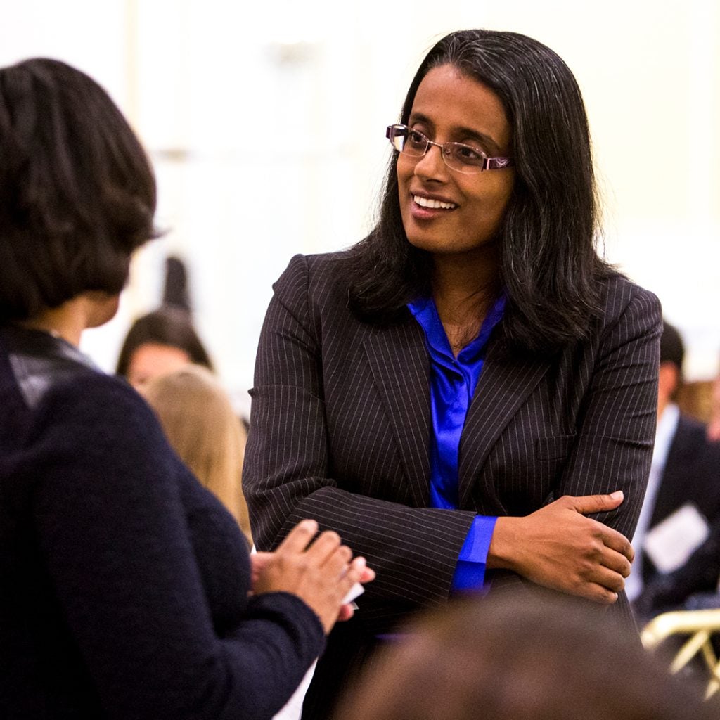Lakshmi Bhojraj and a student talking.