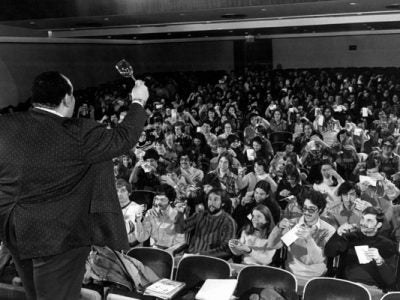 Vance A. Christian raises a glass of wine to 350 students in wine course