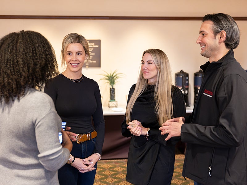 EMBA Americas students having a conversation during a class break.