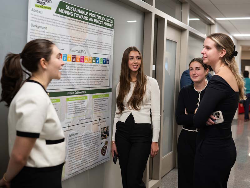 Grand Challenges impact competition team standing around their poster