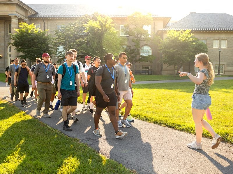 Prospective students on a campus tour on a sunny day.