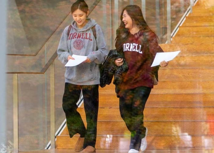two students walking down steps at Tata Center