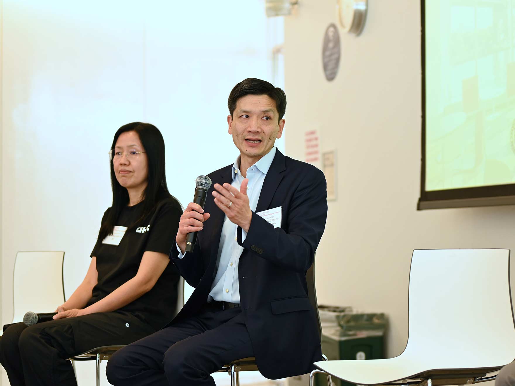 Two presenters at an AI conference at Cornell Tech.