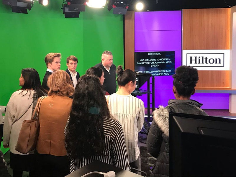 Students in front of a green screen on a tour during a career trek.