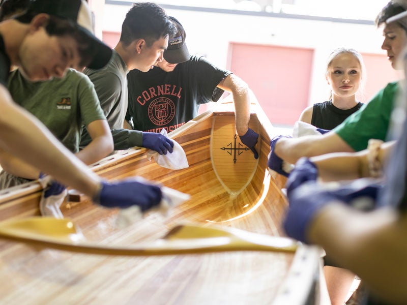 Students working on canoe for the Grand Challenges project