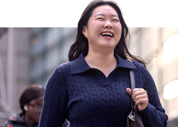 student smiling walking in NYC