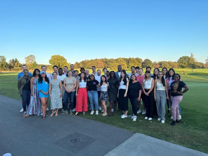 Cornell MBA students from the Johnson Leadership Fellows program pose in a casual group photo outdoors