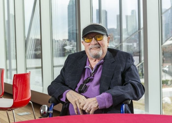 Photo of Sam Seltzer '48 at Cornell Tech with NYC in background