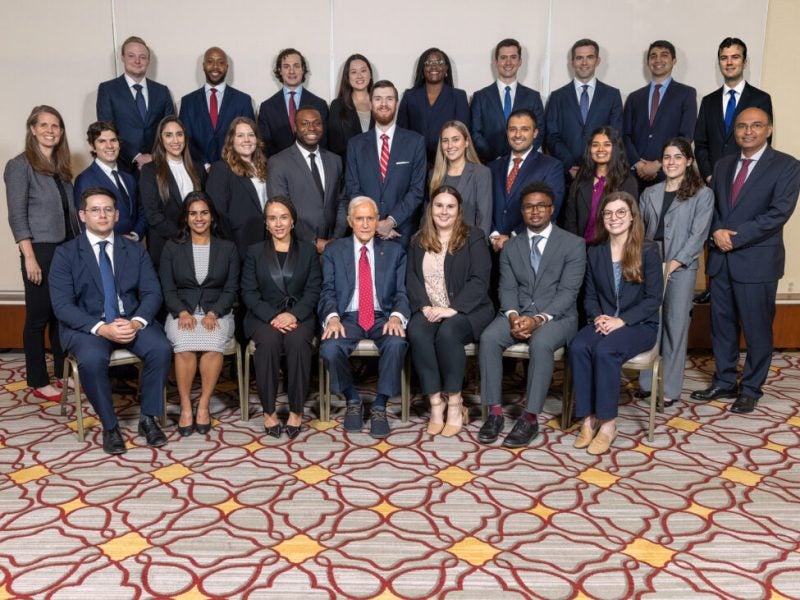 Several young men and women pose in business formal attire as part of the Roy H. Park Leadership Fellows Program