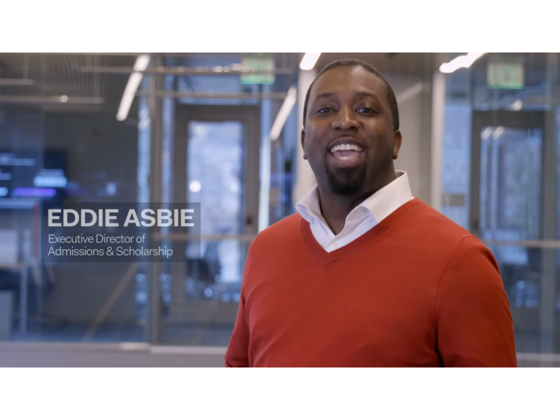 YouTube thumbnail with title text for Eddie Asbie, Executive Director of Admissions and Scholarship for Cornell MBA, wearing a red sweater over a white collared button-down shirt and speaking to the viewer