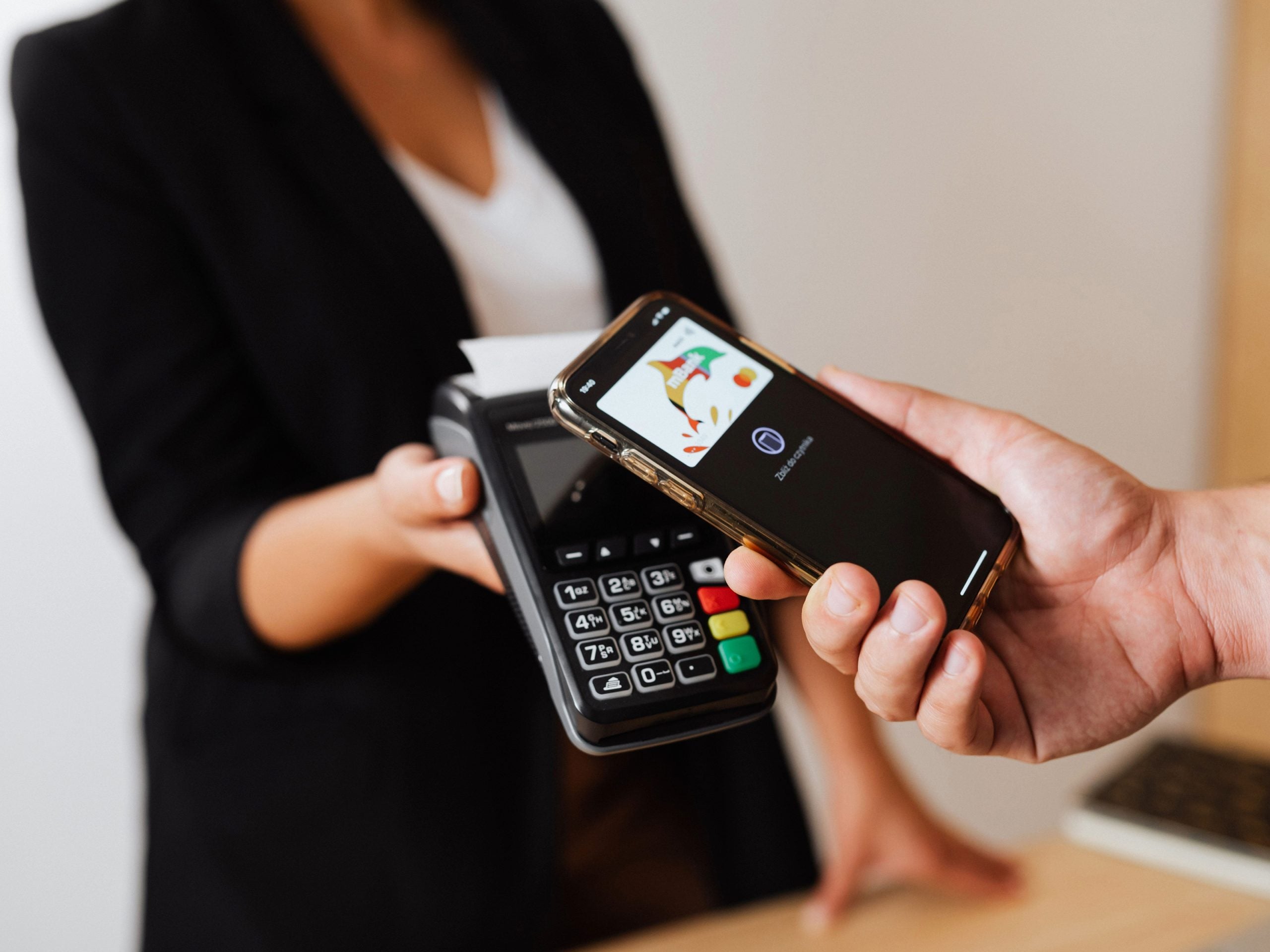 A person making a payment using a smartphone.
