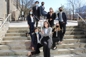 Members of the Cornell Hotel Society, Collegiate Chapter posing outdoors.