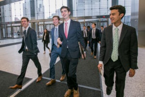 Real Estate Club members walking in their suits.