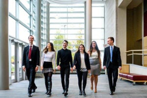 Students walking in formal business attire.