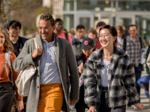 A male and female student student walking on the cornell campus.