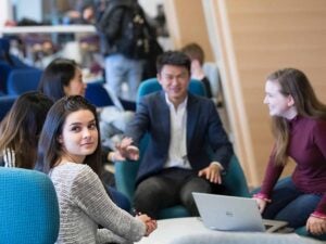 Students around a table in a common space