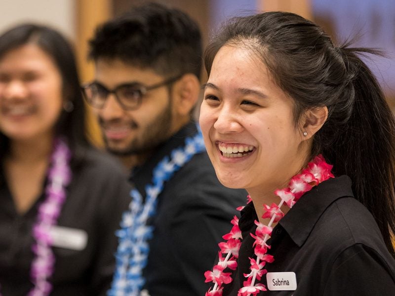 Student workers wearing leis.