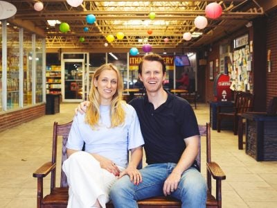 Kristen Ferguson Kopko ’20 and Spencer Kopko ’18 seated on a bench in the Triphammer Marketplace.