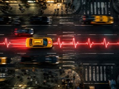 A taxi speeds down a city street on top of a red heart monitor pulse.