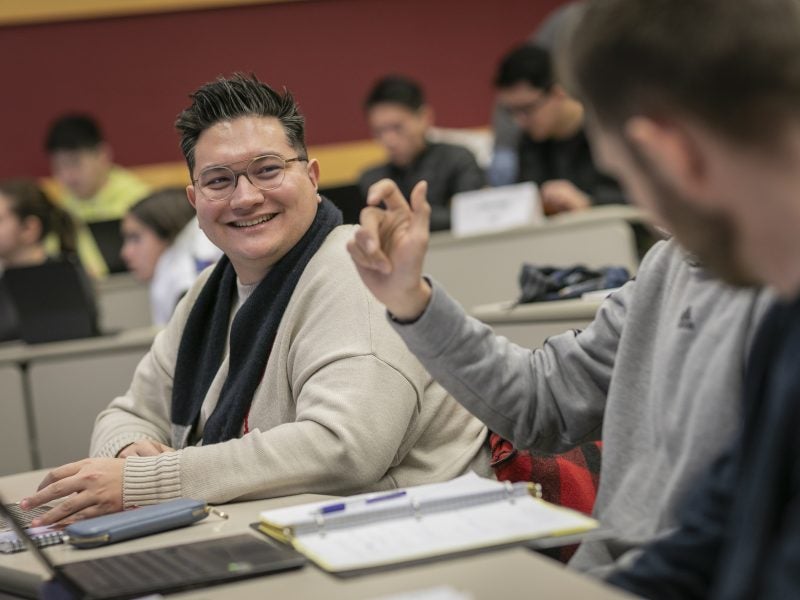 Student looking at other classmate during discussion in Cornell MMH classroom.