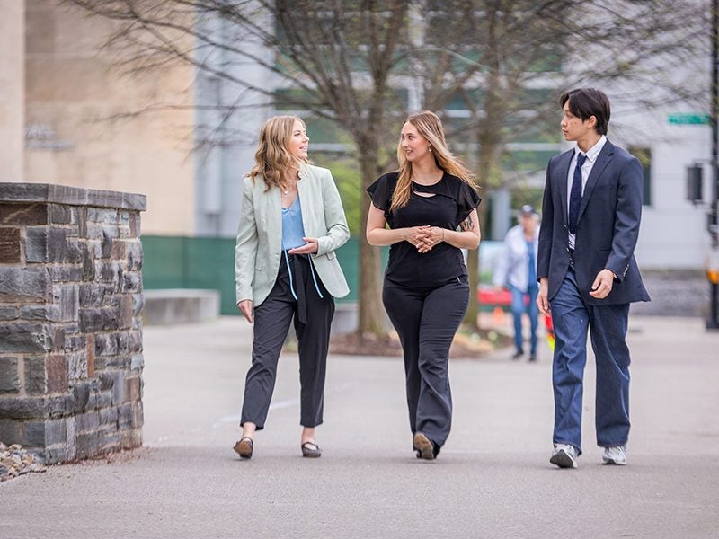 Students in the Cornell MMH and Kyoto MBA program walk outside in front of Statler Hall on Cornell's Ithaca campus.