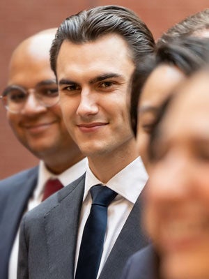 A close-up of adult students in professional attire.