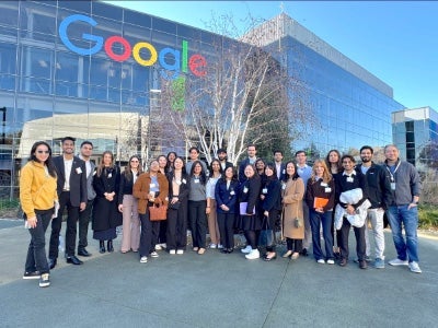 Students pose in front of Google building.