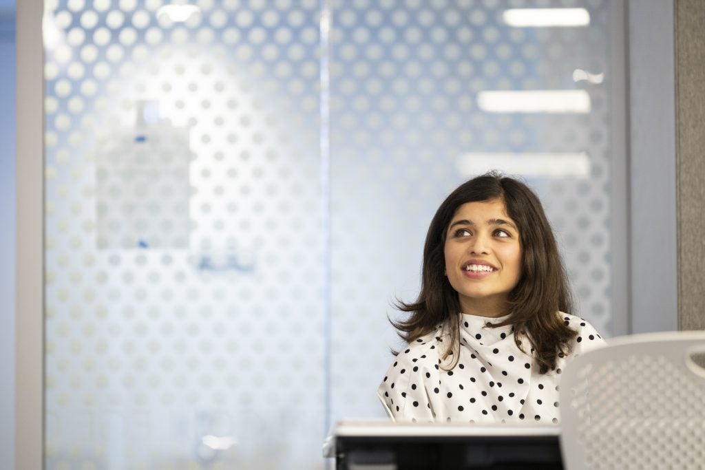 Neerja Joshi, MPS-RE '27 sits and smiles in a classroom at 570 Lex.