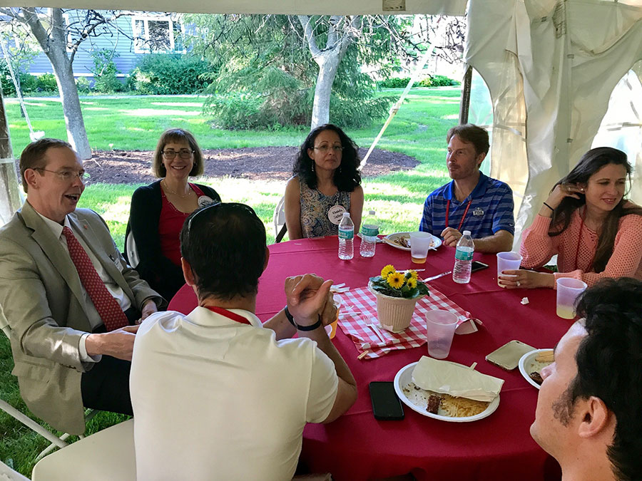 Dean Nelson talking with alumni at the Johnson barbecue 