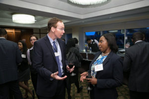 Dean Mark Nelson, left, talks with JMB 2016 attendees during a reception