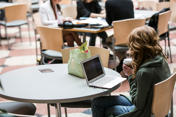 Johnson MBA student in the Dyson Atrium in Sage Hall